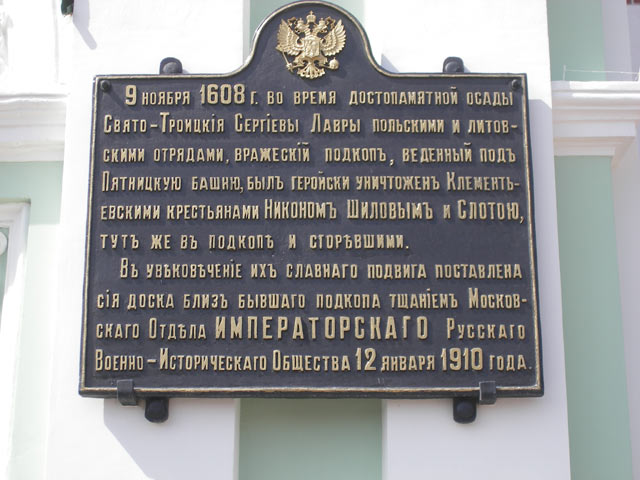 Памятная доска на Святых Воротах<br>"9 ноября 1608 года, во время достопамятной осады Свято-Троицкия Сергиевы Лавры польскими и литовскими отрядами, вражеский подкоп, веденный под Пятницкую башню, был геройски уничтожен клементьевскими крестьянами Никоном Шиловым и Слотою, тут же в подкопе и сгоревшими. В увековечение их славного подвига поставлена сия доска близ бывшего подкопа тщанием Московского Отдела Русского Императорского Военно-Исторического Общества 12 января 1910 года